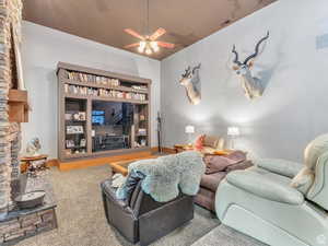 Living room featuring ceiling fan and carpet floors