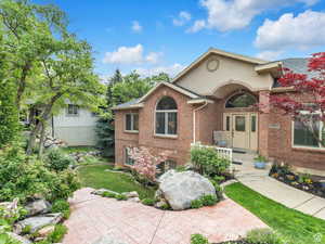 View of front of property featuring brick siding and a front lawn