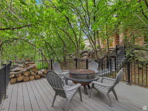 Deck featuring stairs and an outdoor fire pit