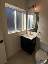 Bathroom with vanity and dark tile patterned floors