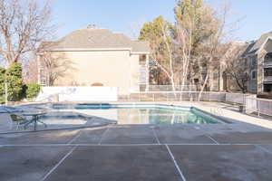 Pool for HOA members and guests featuring a delightful patio and a hot tub.