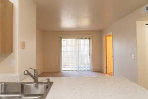 Looking toward the sliding glass doors to the patio complete with tasteful window partitions.