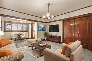 Living room with a chandelier and ornamental molding