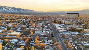 Snowy aerial view featuring a mountain view and a residential view