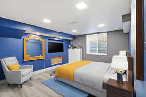 Bedroom featuring wood finished floors and baseboards