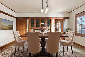 Dining room with crown molding and wood finished floors