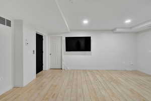 Spare room with light wood-style floors and recessed lighting
