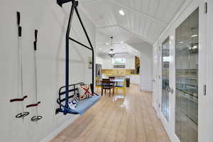 Interior space with light wood-style floors, a chandelier, recessed lighting, lofted ceiling, and french doors