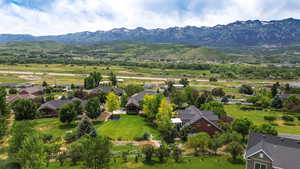 Aerial perspective of suburban area featuring a mountain backdrop