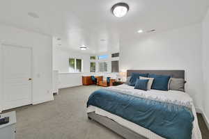 Bedroom featuring light carpet and baseboards
