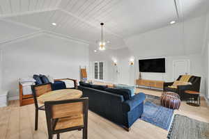 Living area featuring recessed lighting, light wood-type flooring, wood ceiling, vaulted ceiling, and a chandelier
