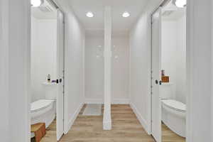 Bathroom with wood finished floors and recessed lighting