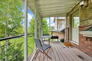 Sunroom / solarium featuring lofted ceiling and a balcony