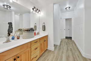 Bathroom featuring double vanity and light wood-type flooring