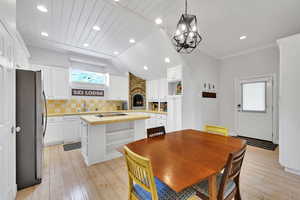 Dining room with light wood-style flooring, recessed lighting, a chandelier, and ornamental molding