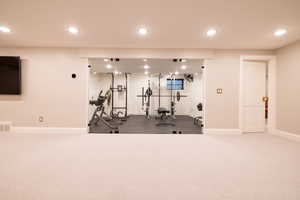 Workout area featuring recessed lighting