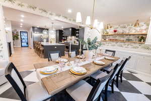 Dining room with a chandelier and recessed lighting