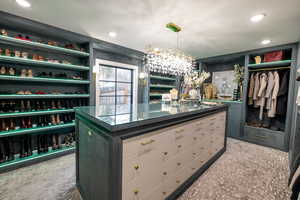 Spacious closet featuring a chandelier