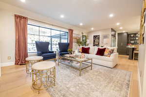 Living area with recessed lighting and light wood-style floors