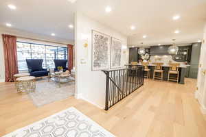Entrance the flows into the living room and kitchen. Stairs leading to the basement