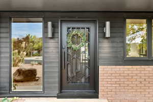 Entrance to property with brick siding