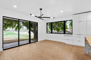 Unfurnished bedroom featuring golf course view, access to exterior, multiple windows, recessed lighting, and ceiling fan