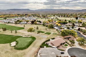 Aerial overview of property's location with nearby suburban area and a mountainous background