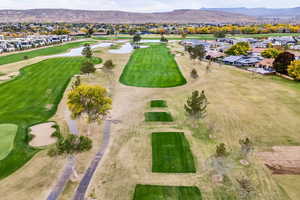 Aerial overview of property's location featuring nearby suburban area and a water and mountain view