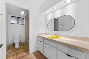 Bathroom with vanity, bathtub / shower combination, and light tile patterned flooring
