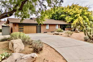 Ranch-style home featuring brick siding and concrete driveway