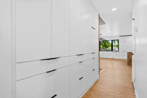 Corridor with recessed lighting and light wood-type flooring