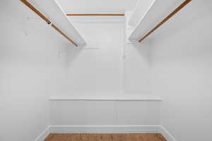 Walk in closet featuring wood finished floors