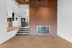 Unfurnished living room featuring a fireplace, wood finished floors, and recessed lighting