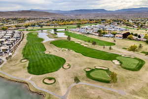 Aerial perspective of suburban area with a water and mountain view and a local golf course