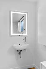 Bathroom with a sink and baseboards
