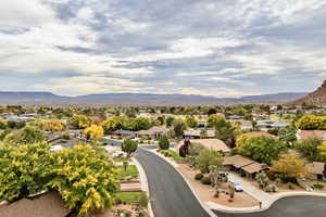 Aerial perspective of suburban area featuring a mountain backdrop