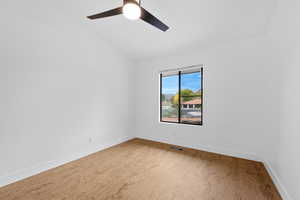 Unfurnished room featuring vaulted ceiling and light wood finished floors