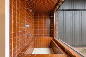 Full bath featuring tiled shower