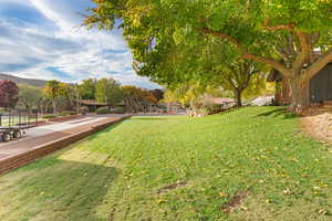 View of grassy yard featuring a mountain view