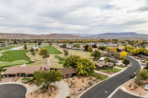 Aerial view of residential area with mountains and a golf course