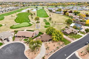 Aerial overview of property's location with nearby suburban area, mountains, and a local golf course