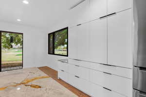 Empty room featuring recessed lighting and light marble finish floors
