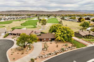 Aerial view of residential area featuring a golf club and mountains