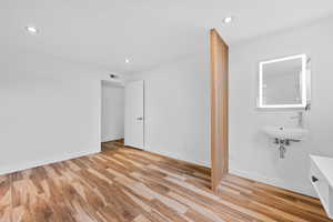 Unfurnished bedroom featuring light wood finished floors and recessed lighting