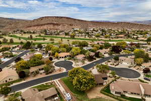 Aerial overview of property's location featuring a mountain backdrop and nearby suburban area