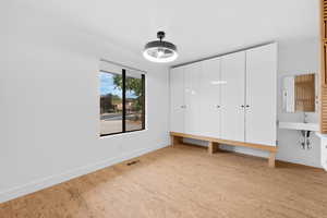Unfurnished bedroom with baseboards and light wood-style floors
