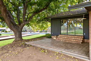 View of home's community featuring entry steps and a lawn