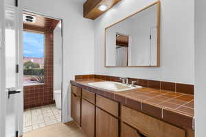 Full bath with vanity and curtained shower