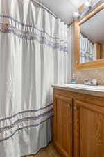 Full bathroom featuring a shower with curtain and vanity