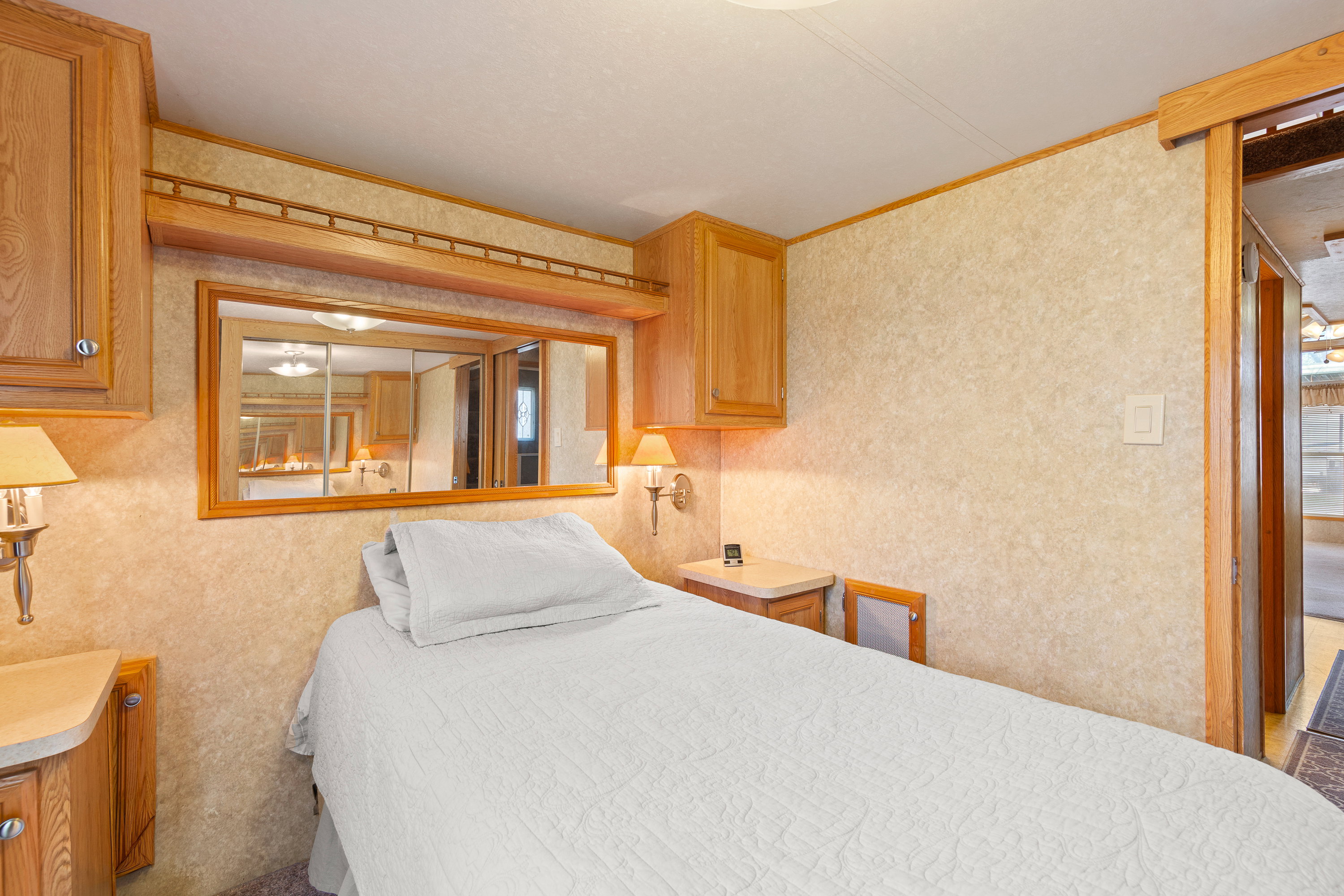 Bedroom with wallpapered walls and ornamental molding